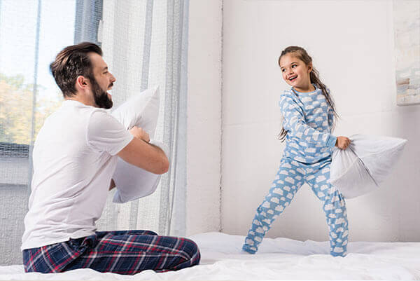Father & Daughter Playing with pillows